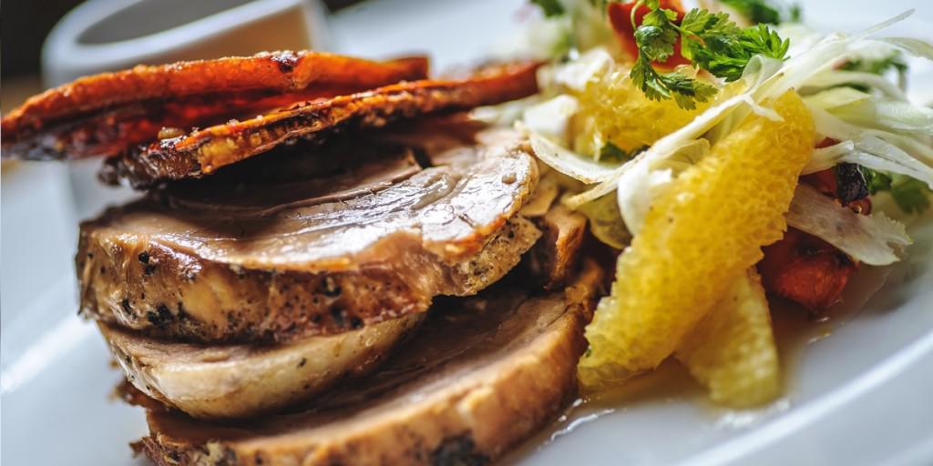 Slow roast pork belly with fennel, carrot & orange salad